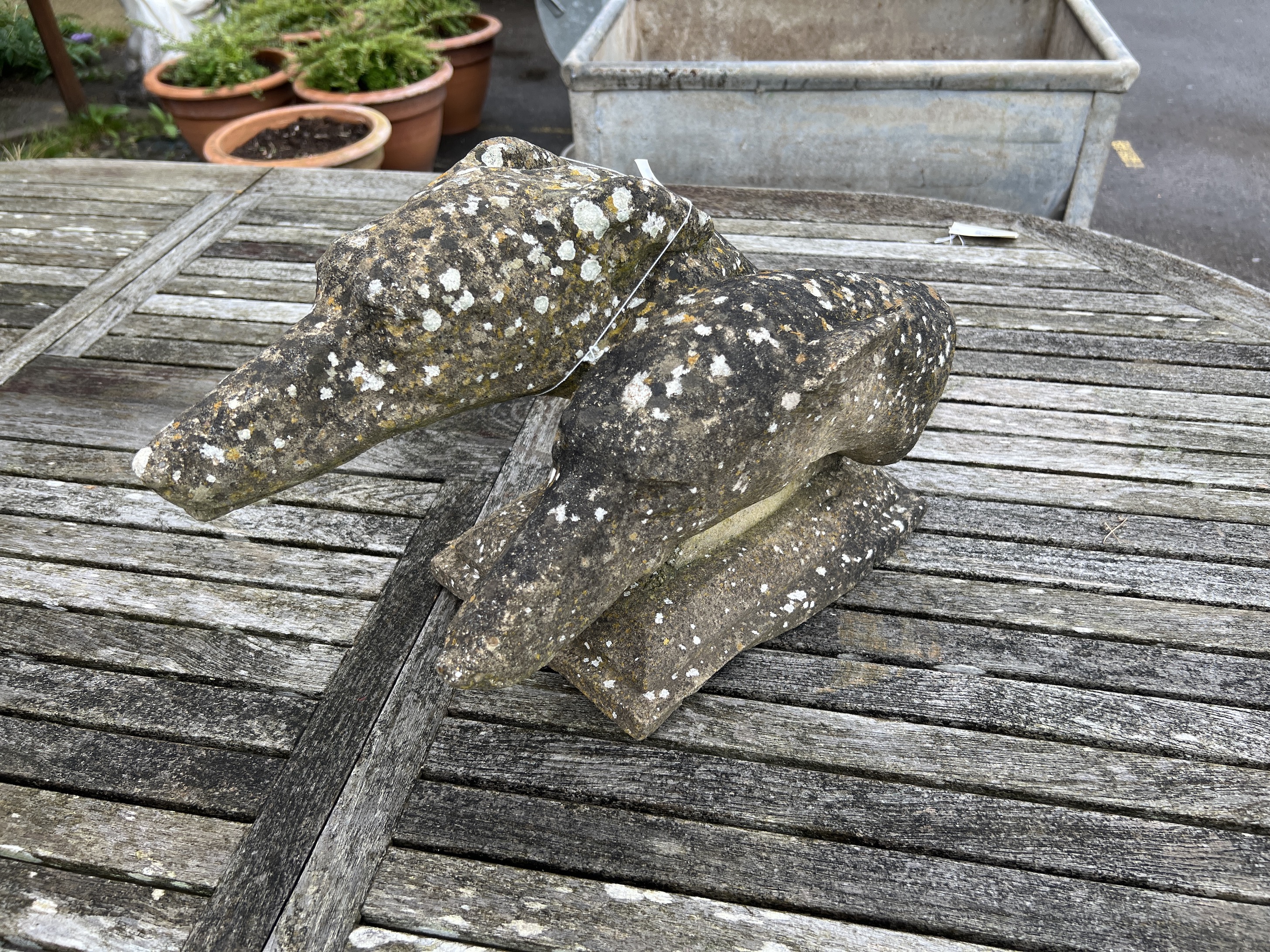 A reconstituted stone double greyhound head garden ornament, width 36cm, depth 23cm, height 28cm